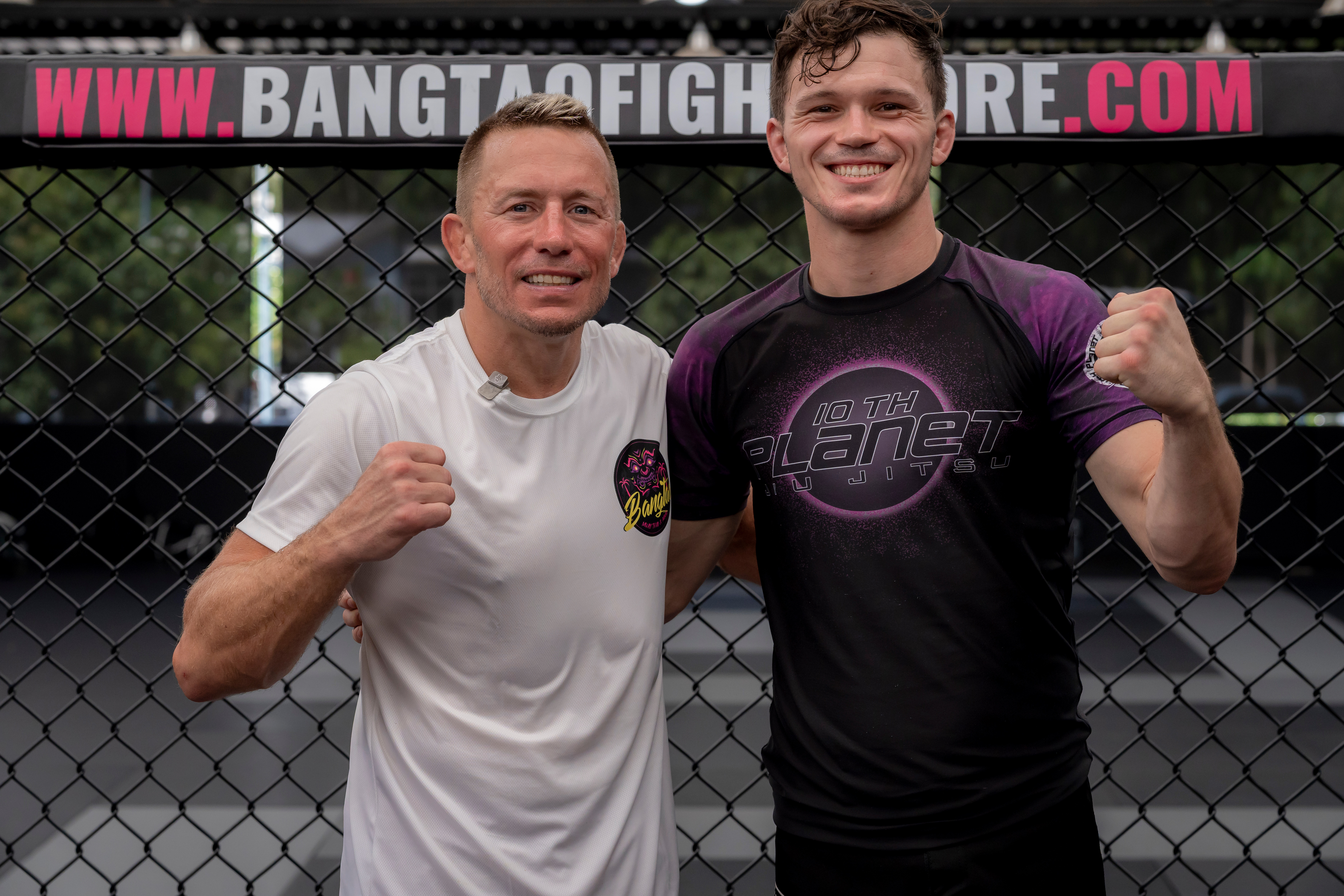 Coach Alex Pyle with a fighter stance in front of an MMA cage